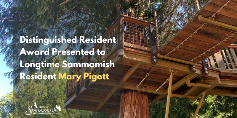 Distinguished Resident Award Presented to Longtime Sammamish Resident Mary Pigott. The treehouse at Big Rock Park Central is in the background.